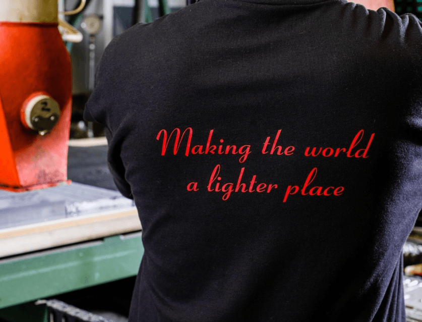 a tshirt that has 'making the world a brighter place' embroidered on the back